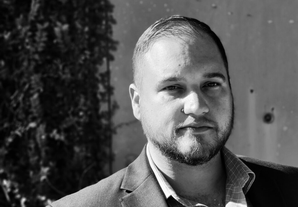 Black-and-white headshot of Clayton Bradshaw-Mittal